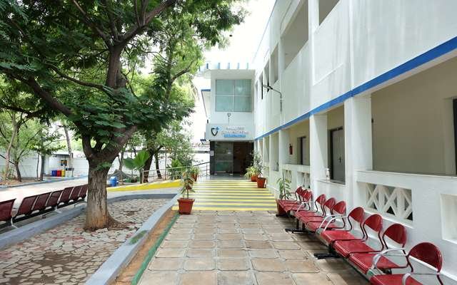 மர நிழலில் நடைபாதை — The tree-shaded walk to the entrance of Sugapriya Hospital, Madurai